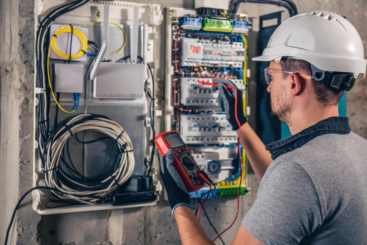 man-an-electrical-technician-working-in-a-switchboard-with-fuses